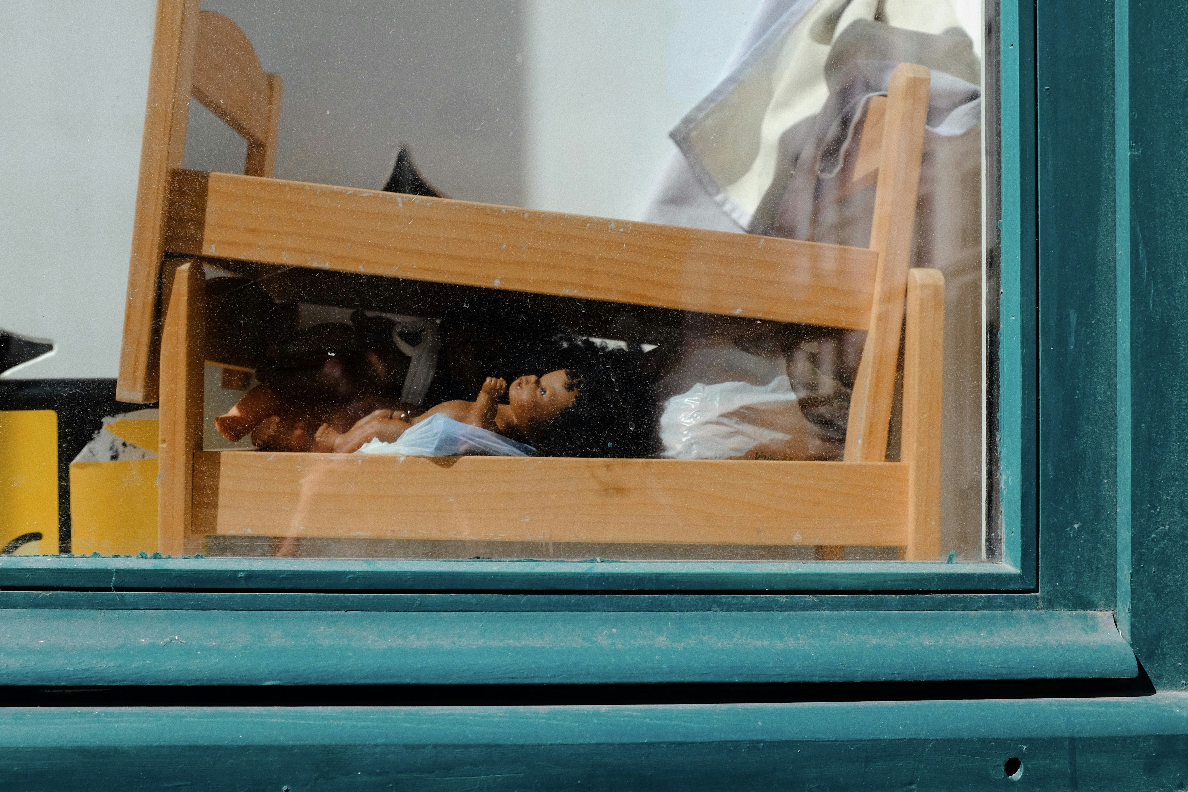 A wooden chair sitting in front of a window