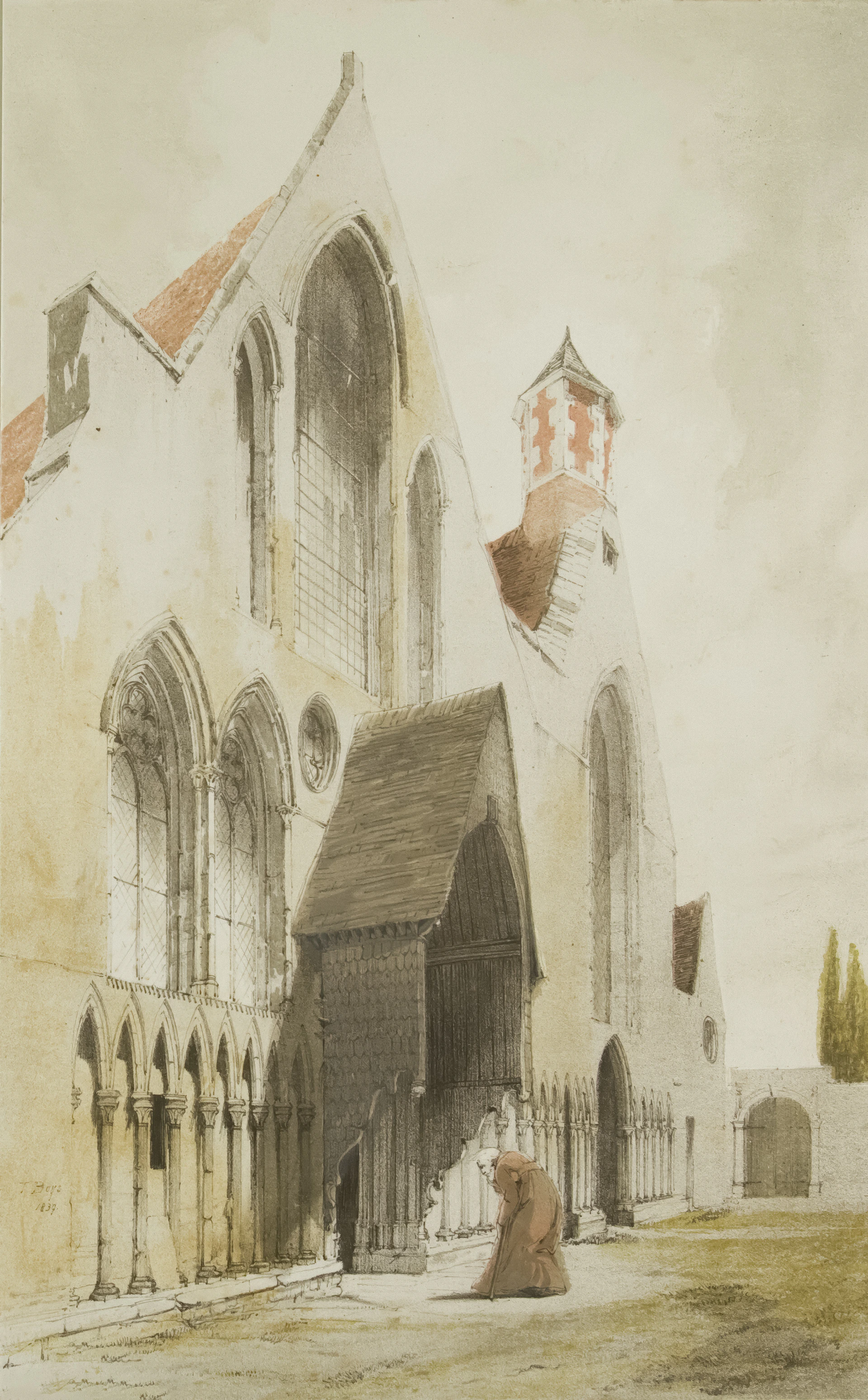 A monk kneels before a large stone building entrance.