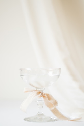 A wine glass with a bow on it