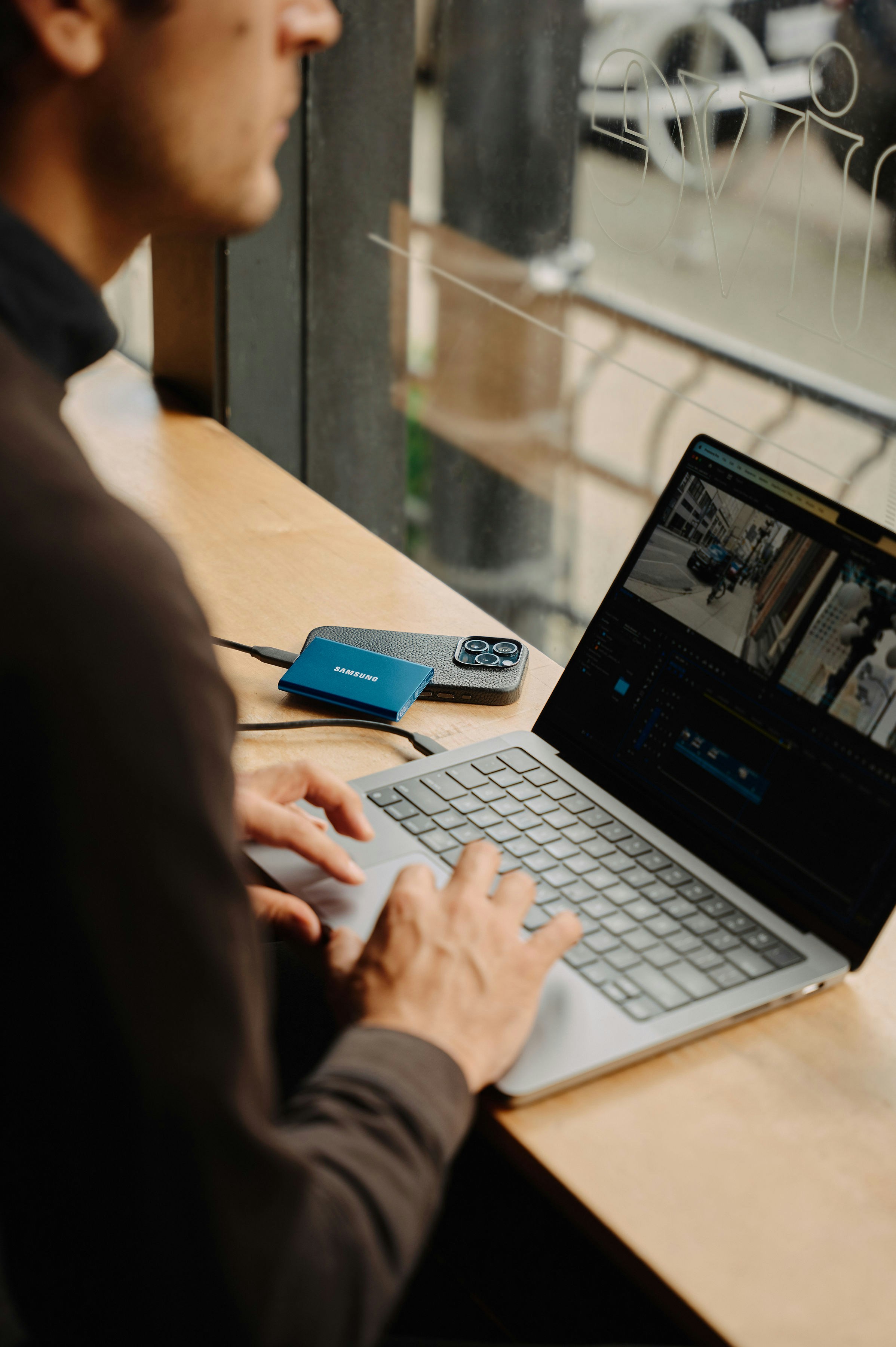 A man sitting at a table using a laptop computer