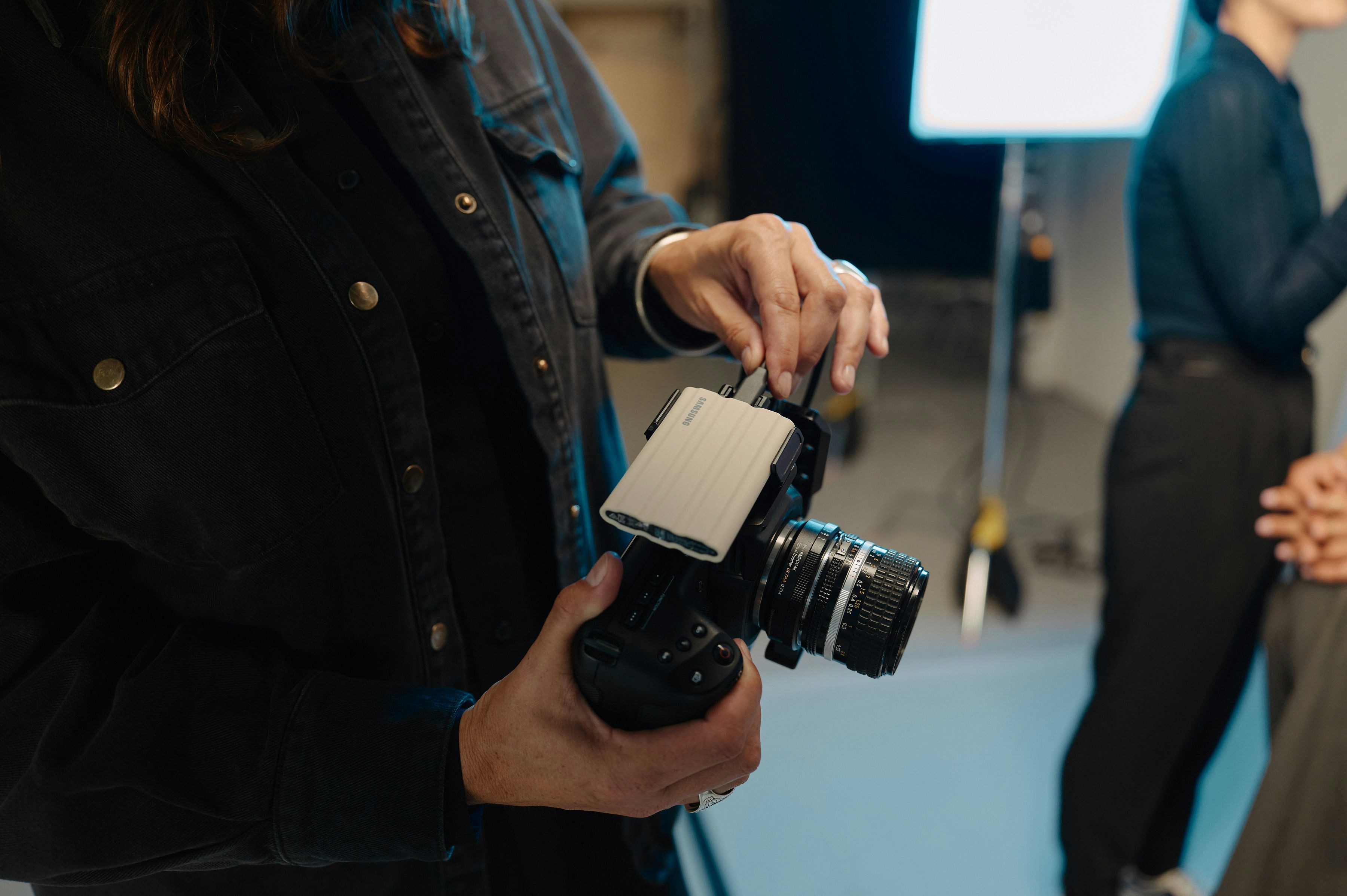A woman holding a camera in front of a group of people