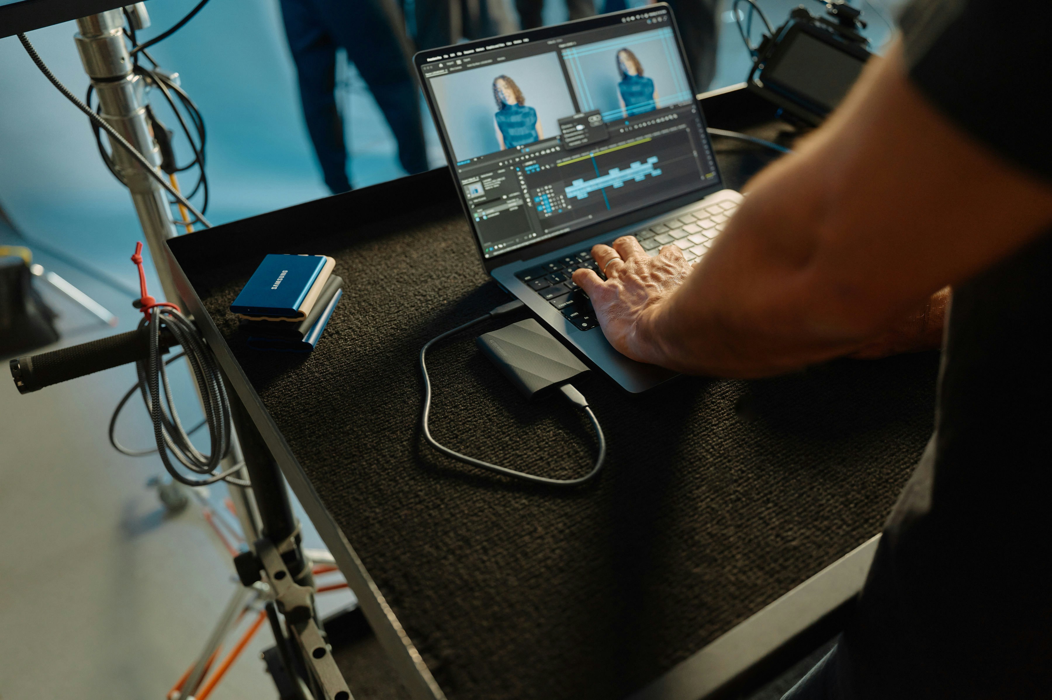 A man using a laptop computer on top of a desk