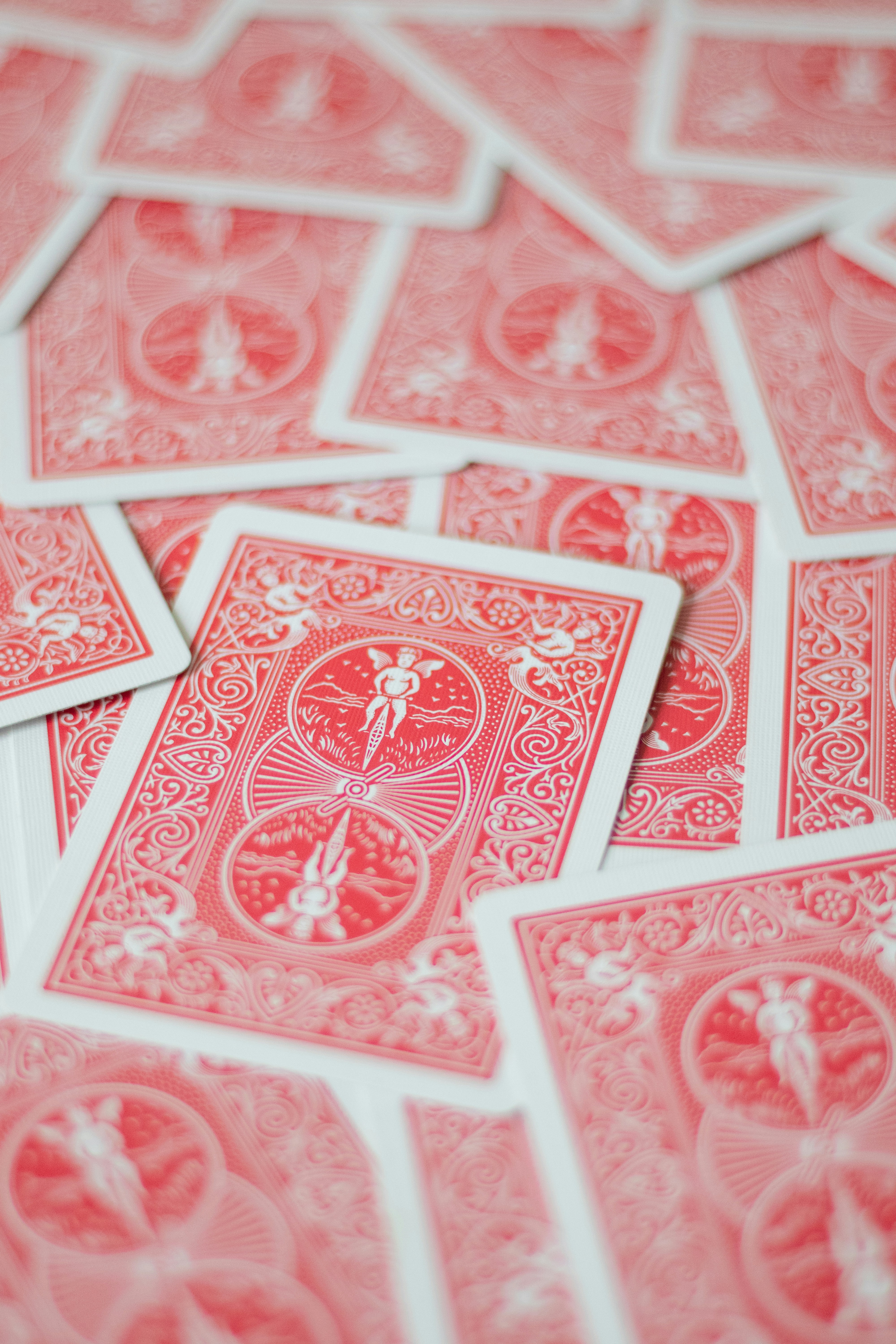 A pile of red playing cards stacked on top of each other