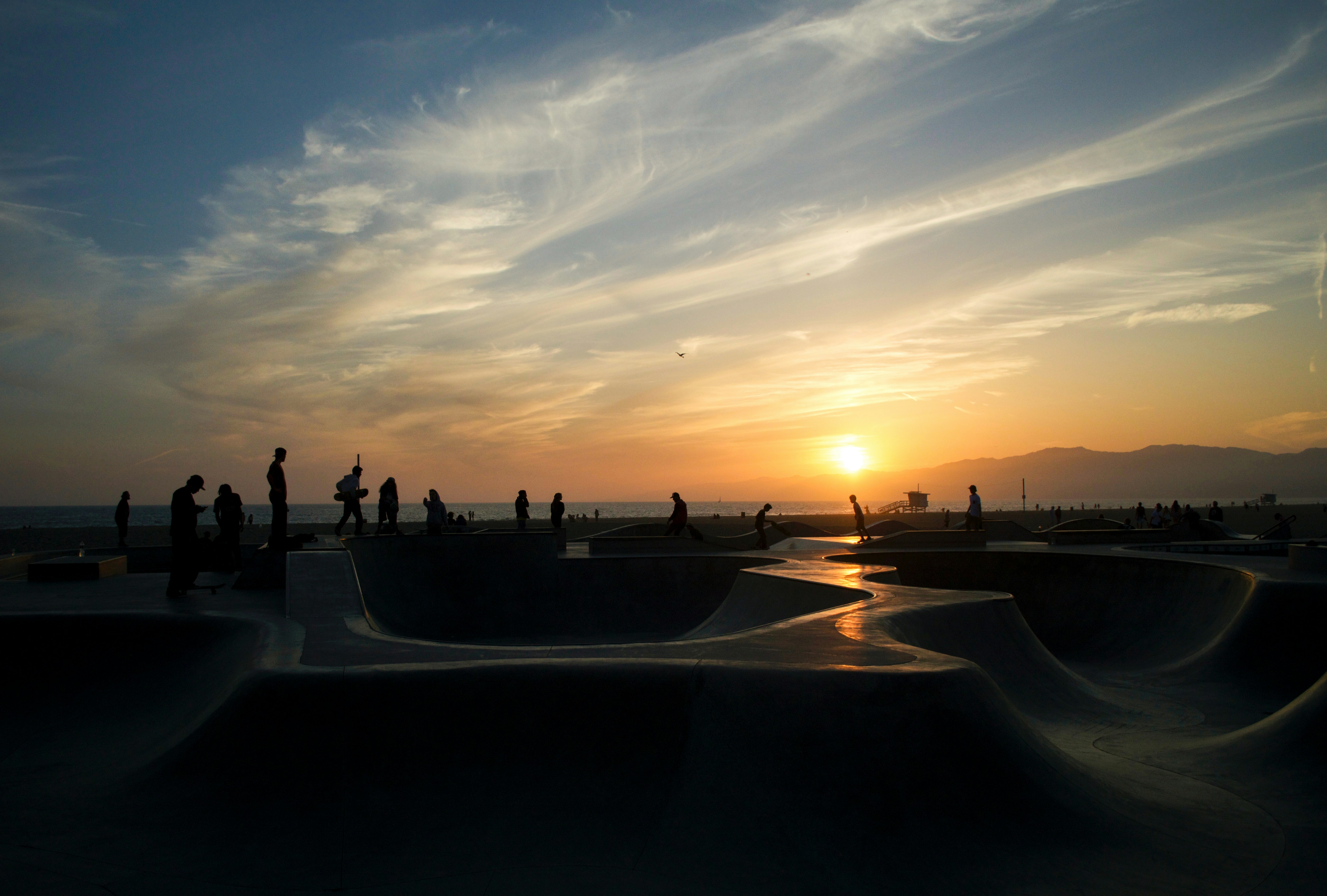 A group of people standing on top of a sandy beach