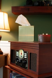 A radio sitting on top of a custom-made table next to an ikea lamp
