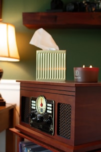 A radio sitting on top of a custom-made table next to an ikea lamp