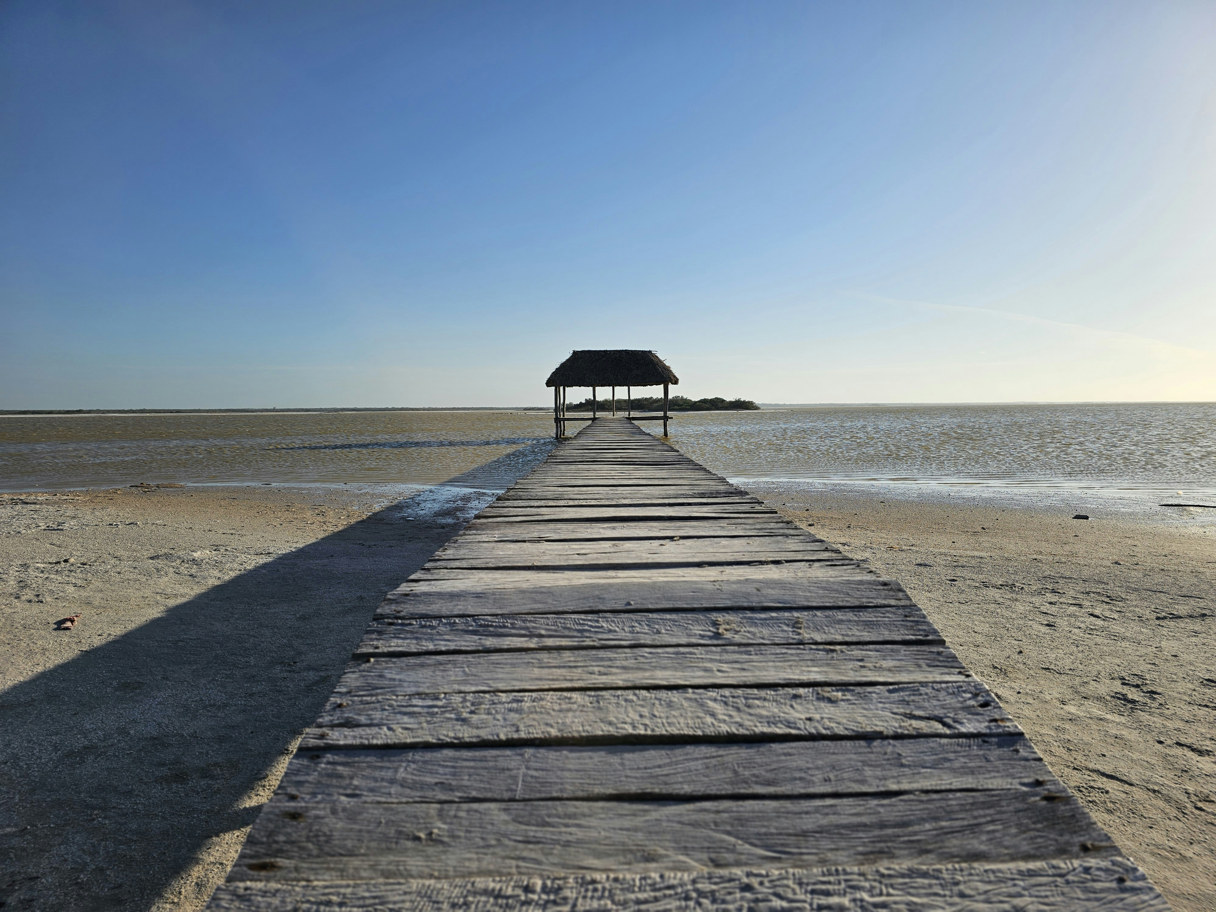 A long pier stretches out into the ocean