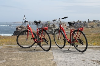 Two red bikes parked next to each other