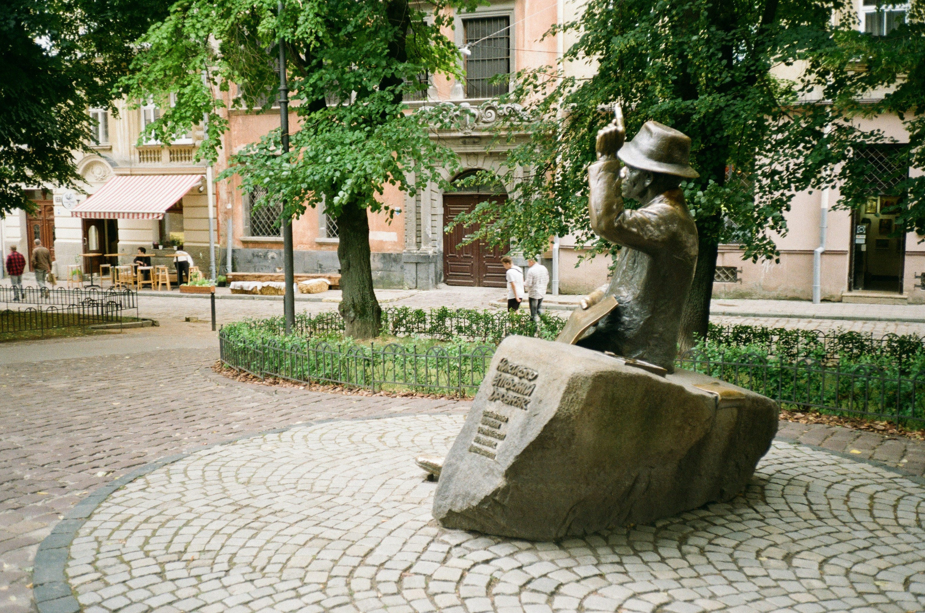 A statue of a person sitting on a rock