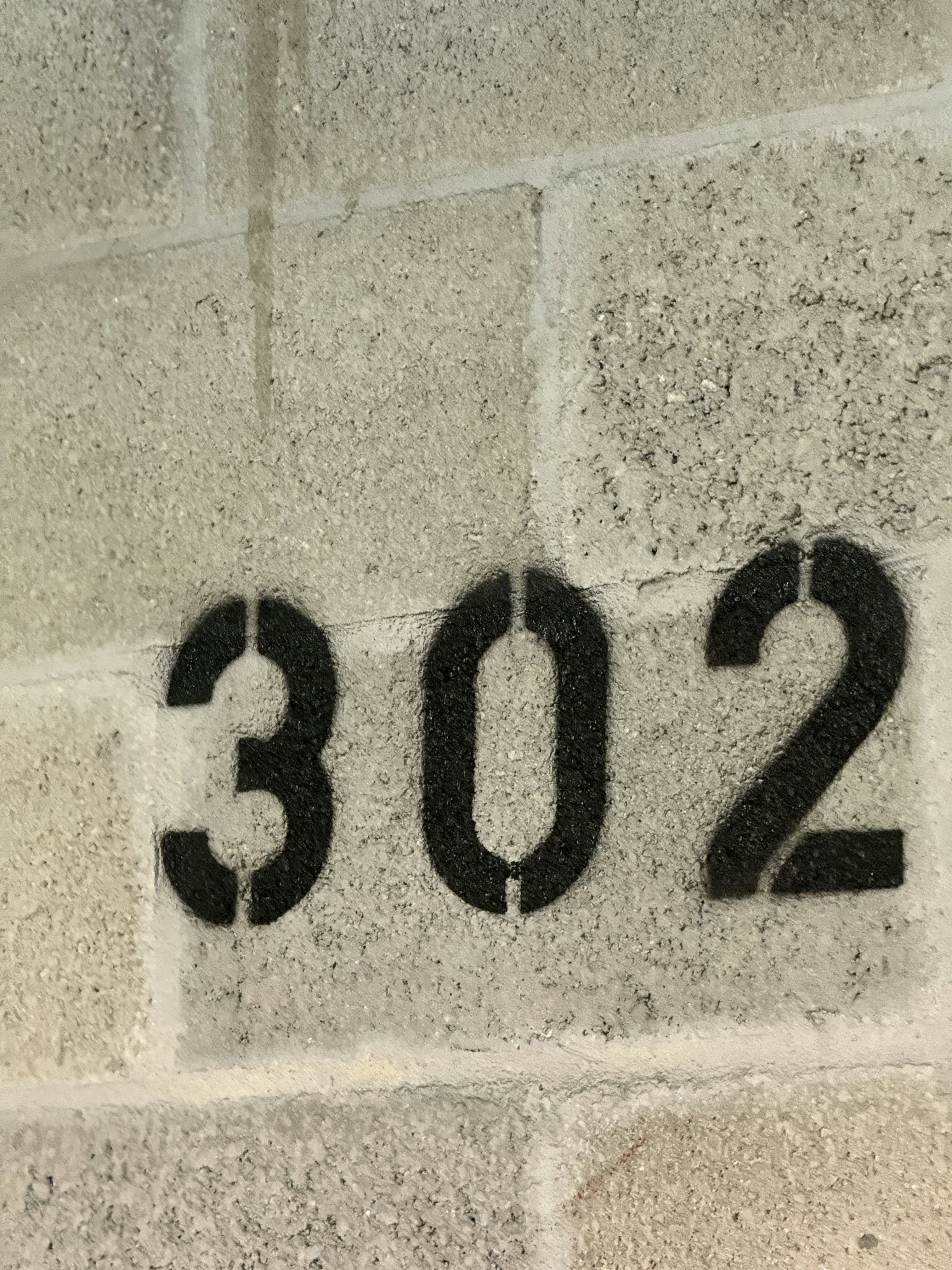 A close up of a number on a brick wall