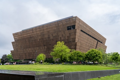 A large building sitting on top of a lush green field