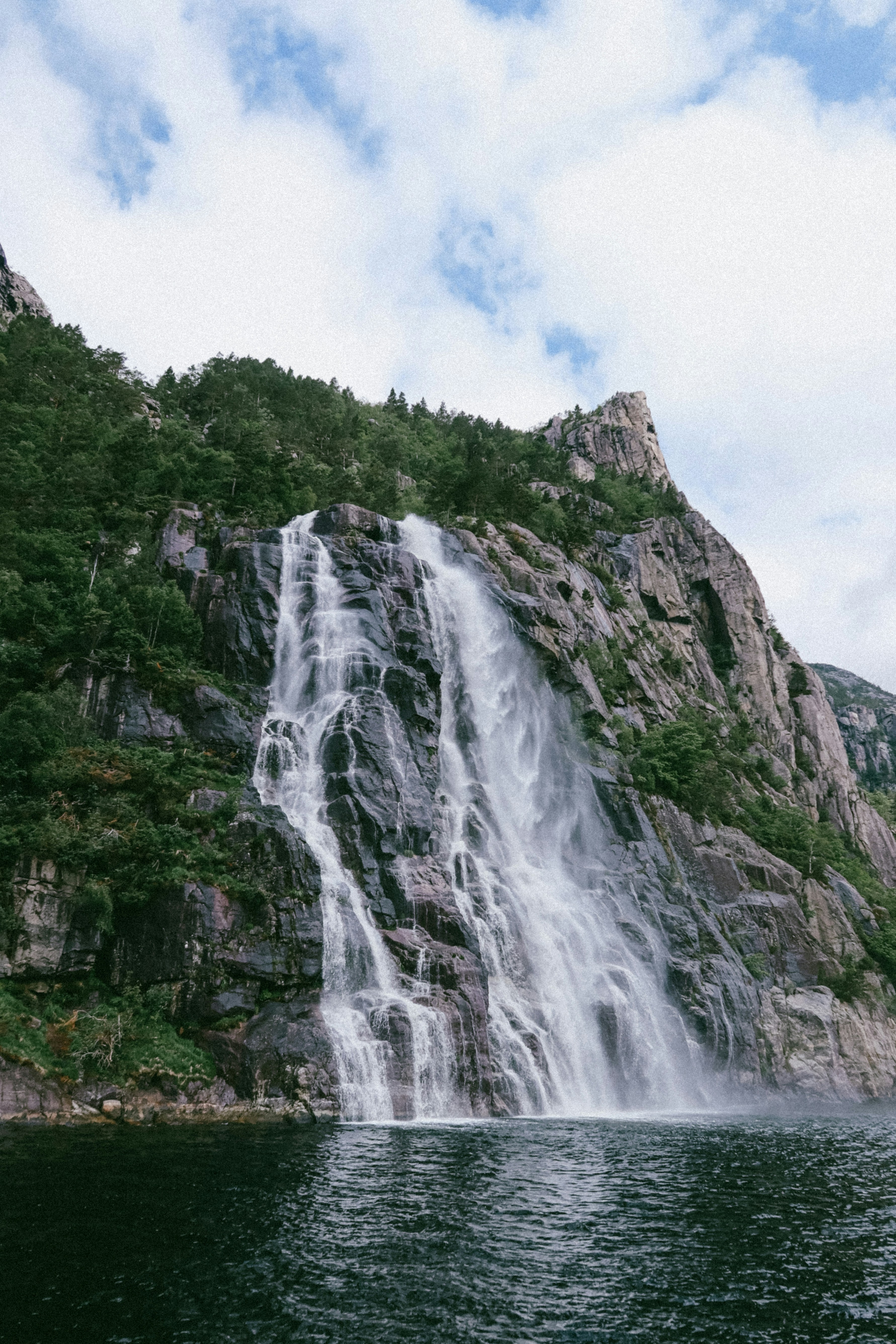 A large waterfall in the middle of a body of water