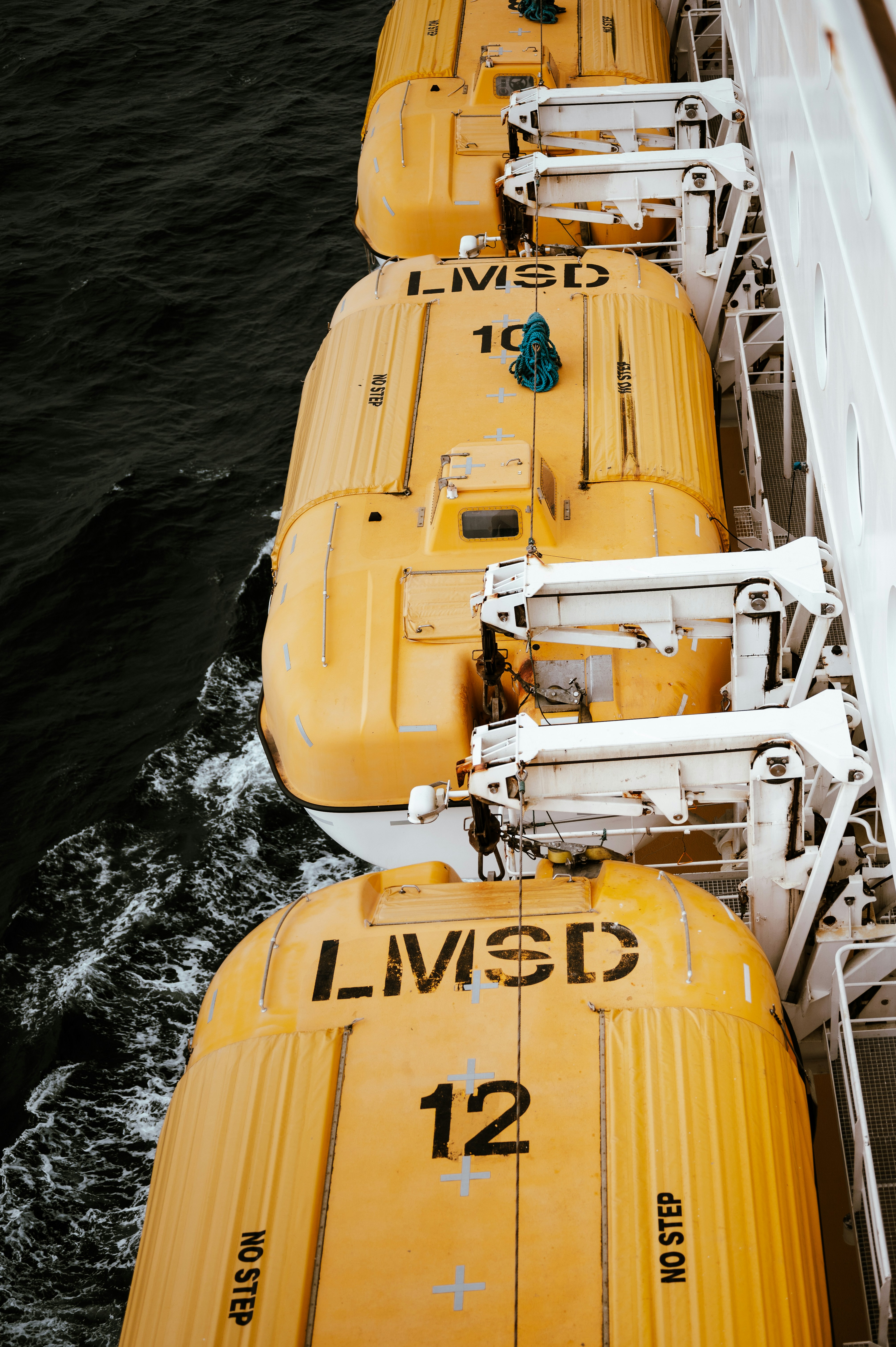 A row of yellow life jackets sitting on top of a boat