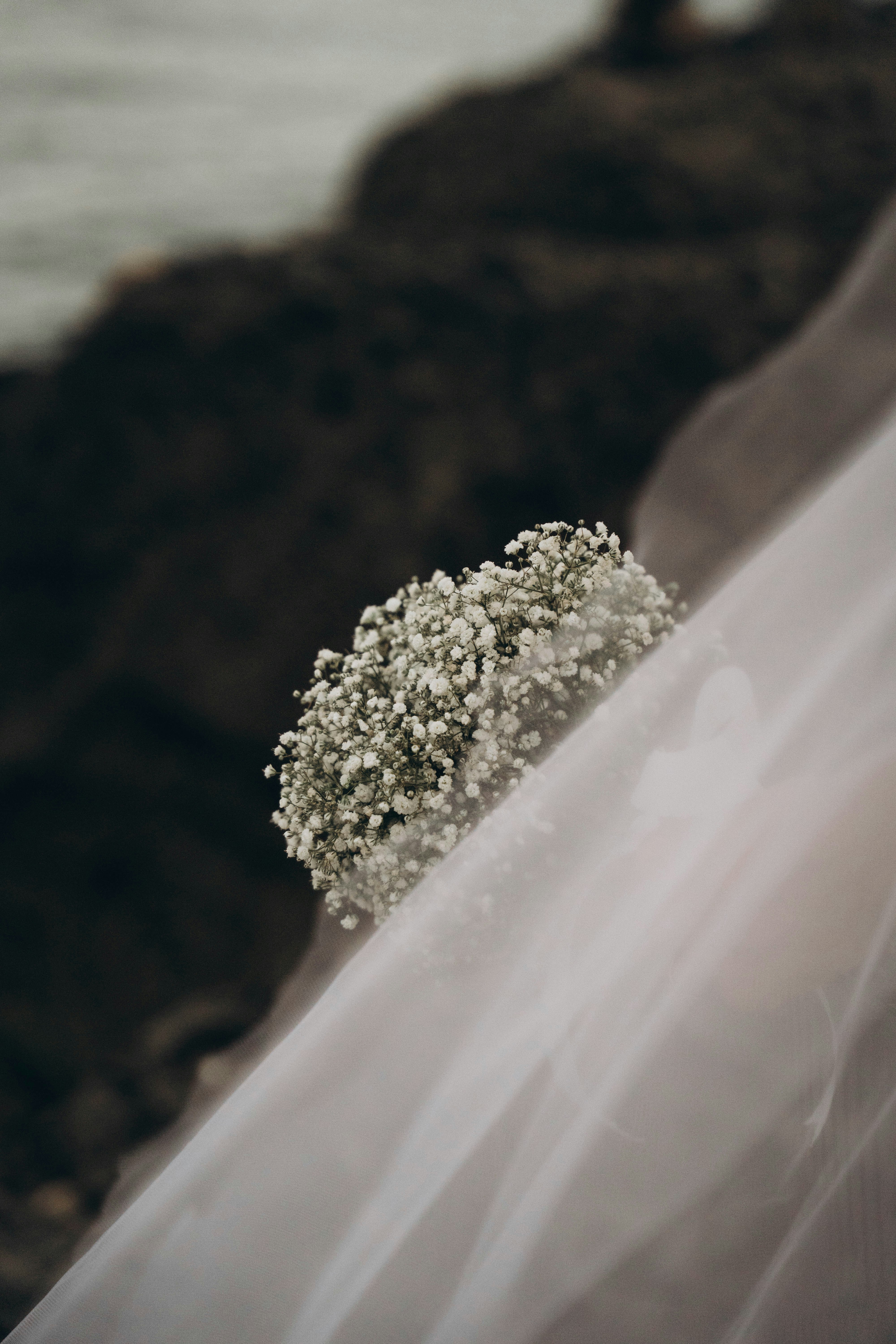 A bride holding a bouquet of white flowers