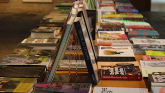 A row of books sitting on top of a wooden table