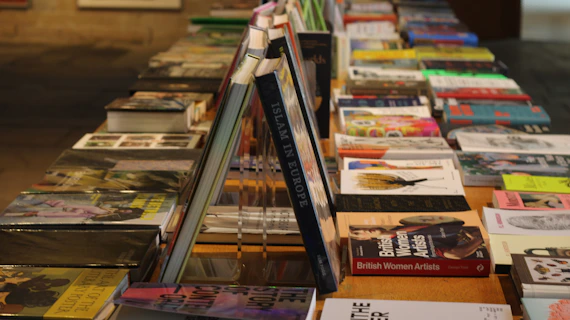 A row of books sitting on top of a wooden table