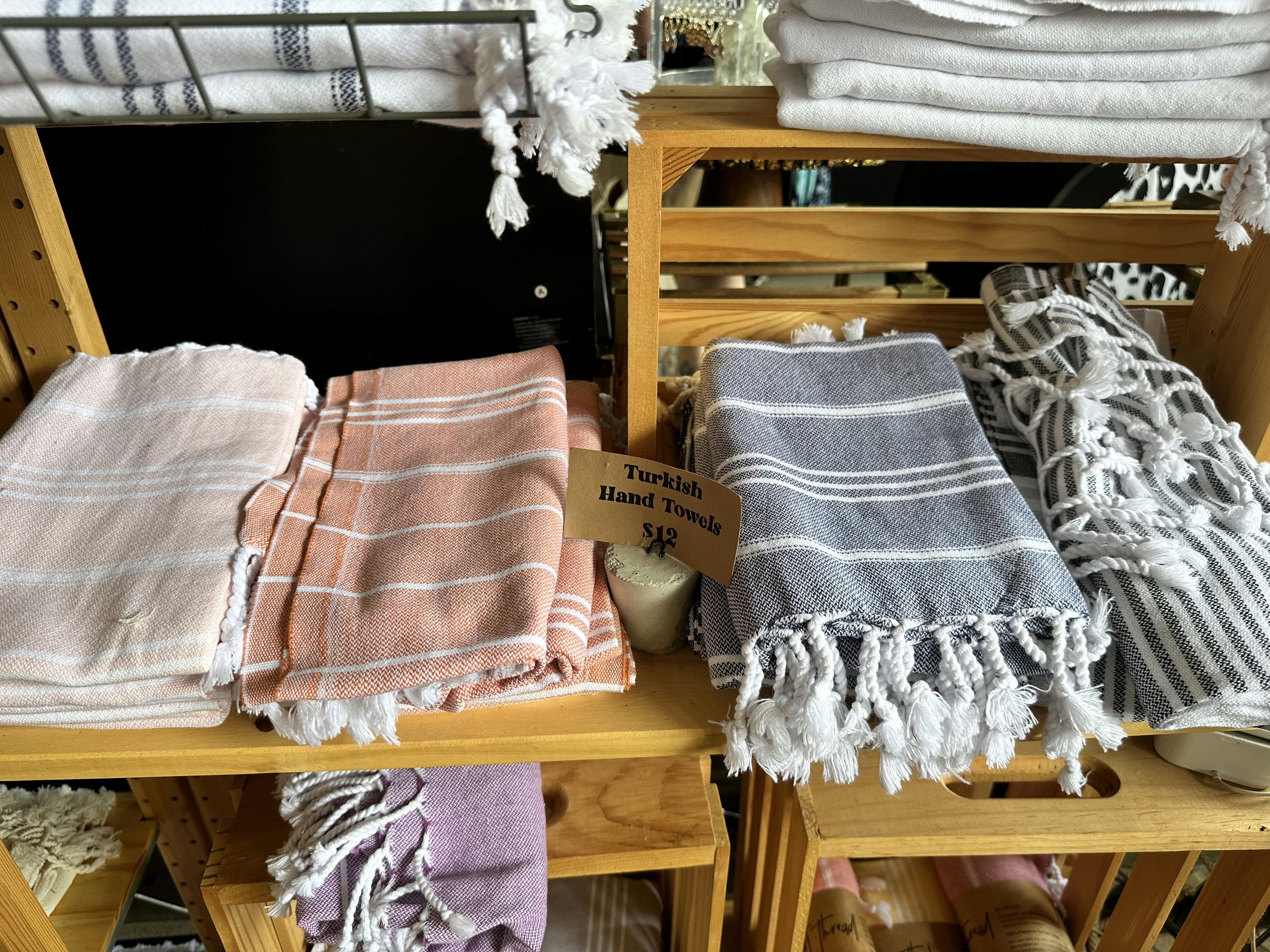 A pile of towels sitting on top of a wooden table