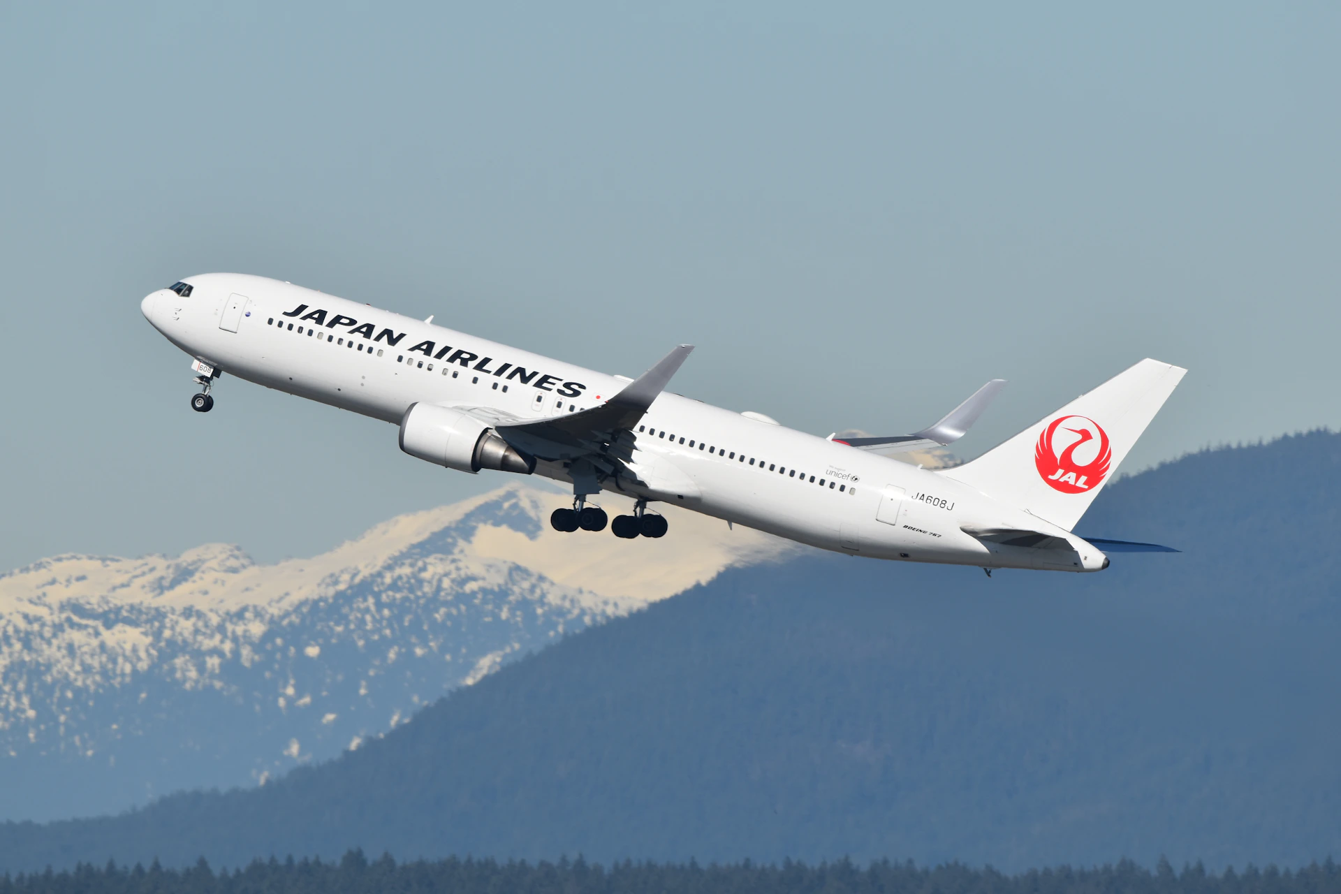 A large jetliner flying through a blue sky