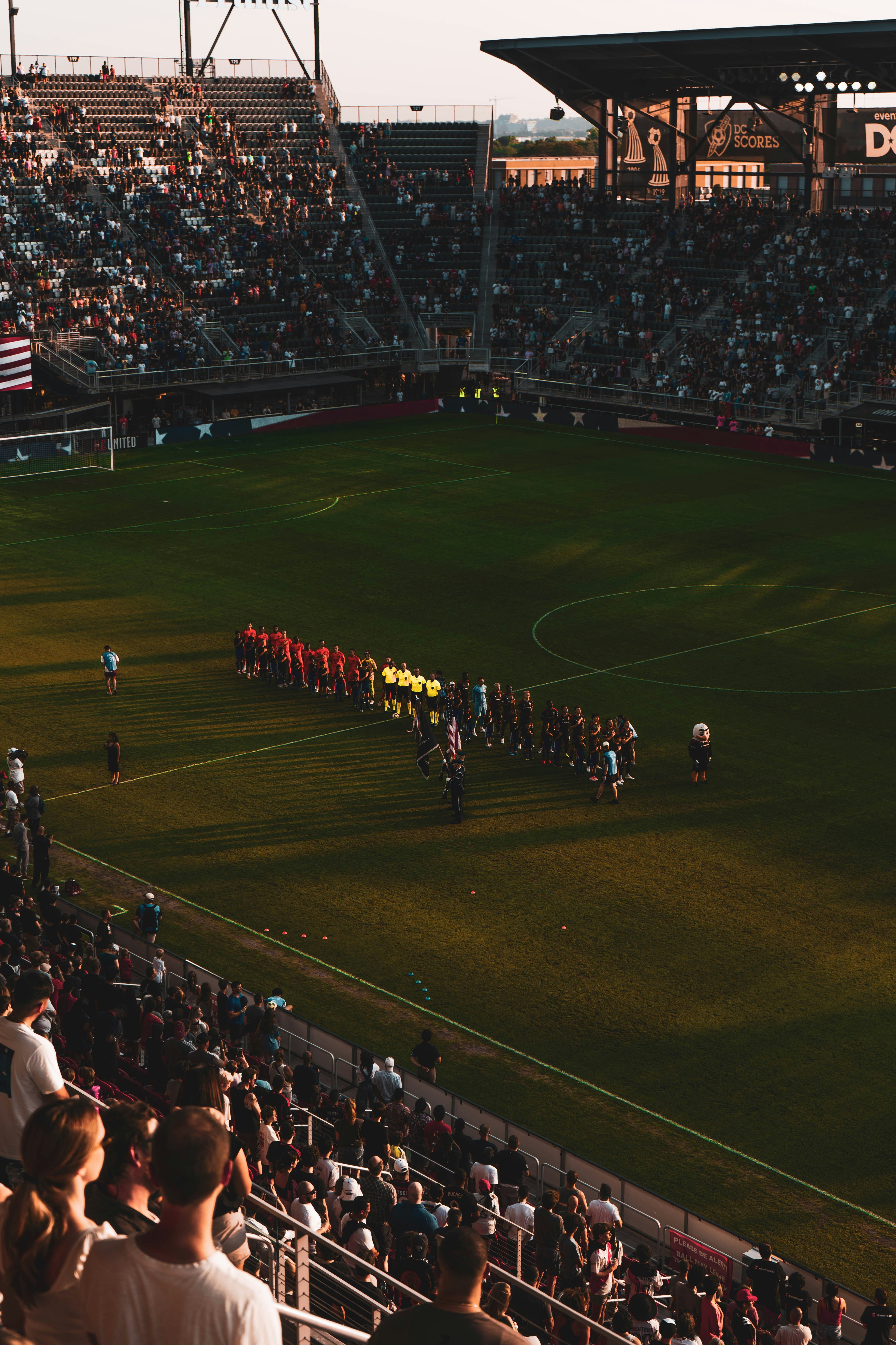 A group of people standing on top of a soccer field
