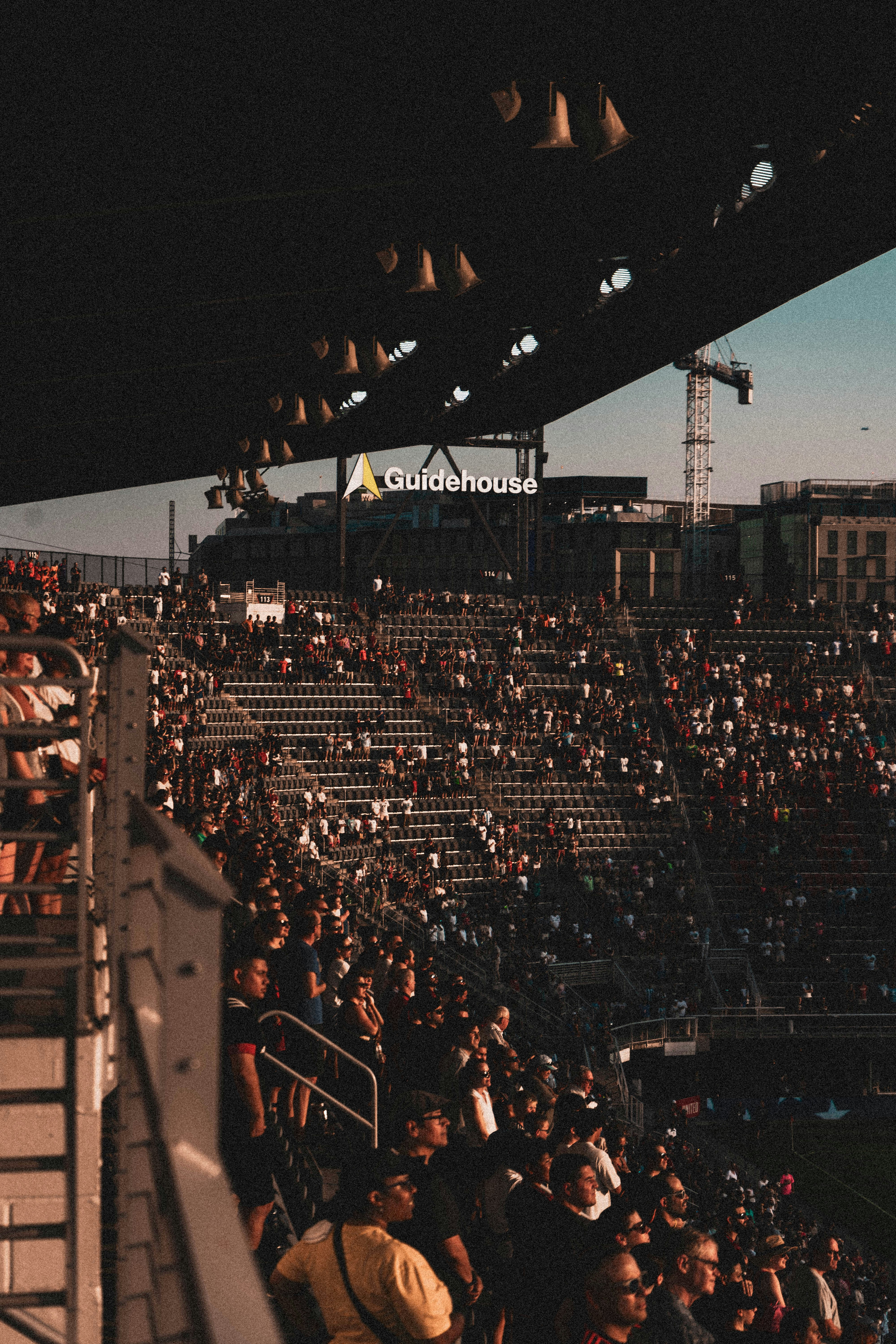 A large crowd of people sitting in a stadium