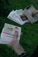 A person holding a bunch of cards in their hands