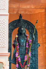 A statue of a person with a flower garland around his neck
