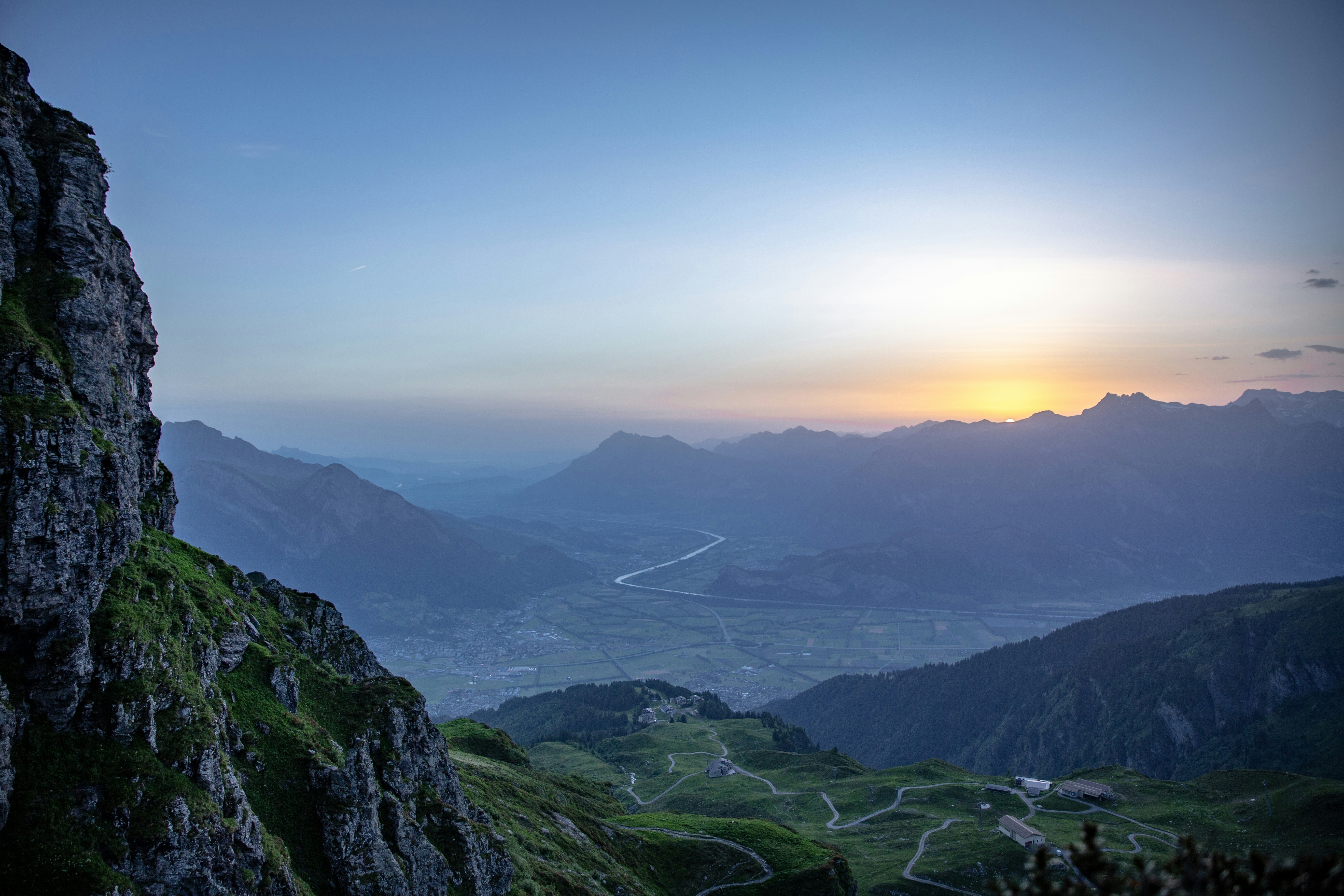 The sun is setting over the mountains and valleys photo – Free Sunrise ...