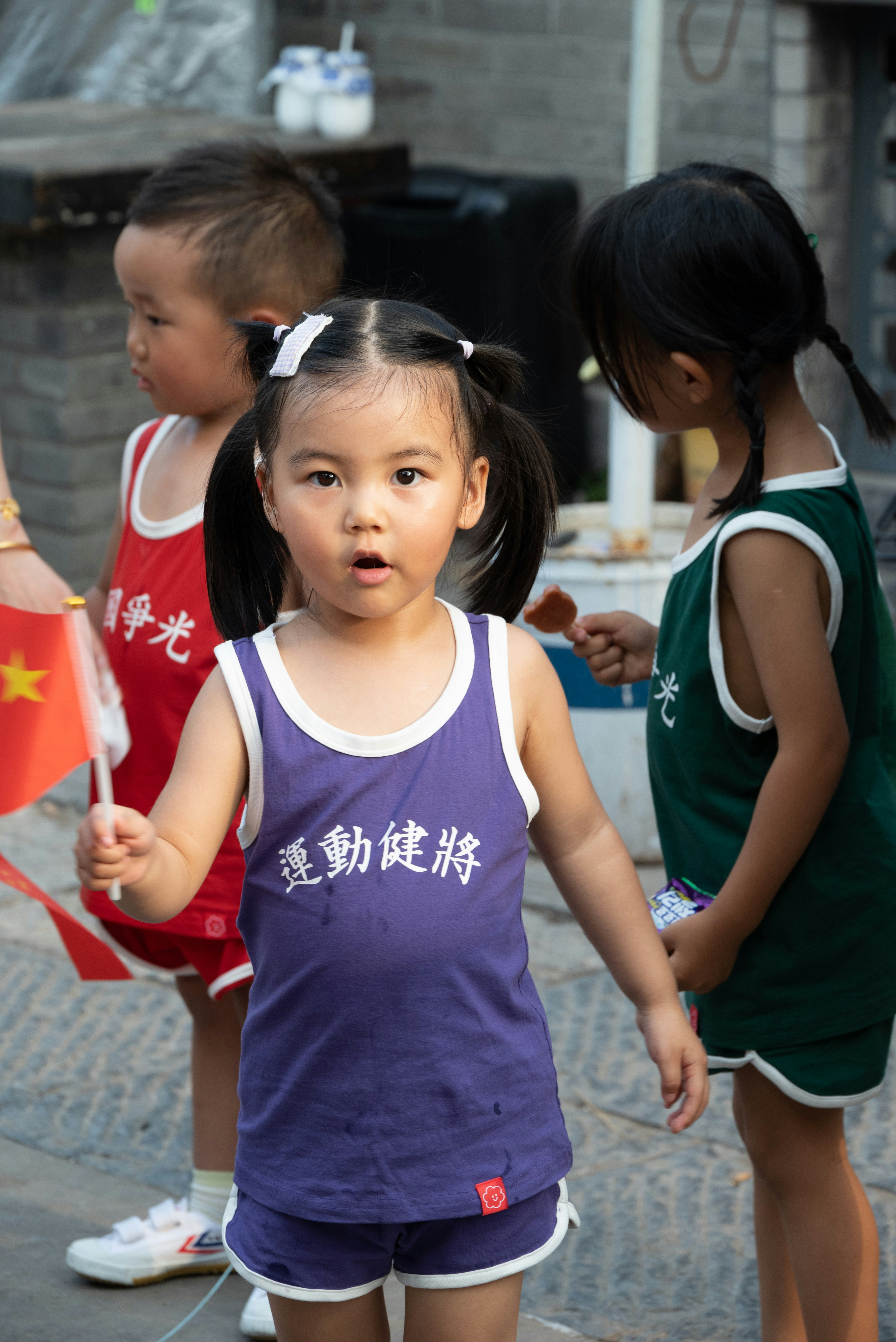A group of young children standing next to each other