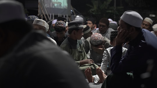 A group of people standing around each other