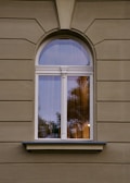 A window on a building with a tree in the background