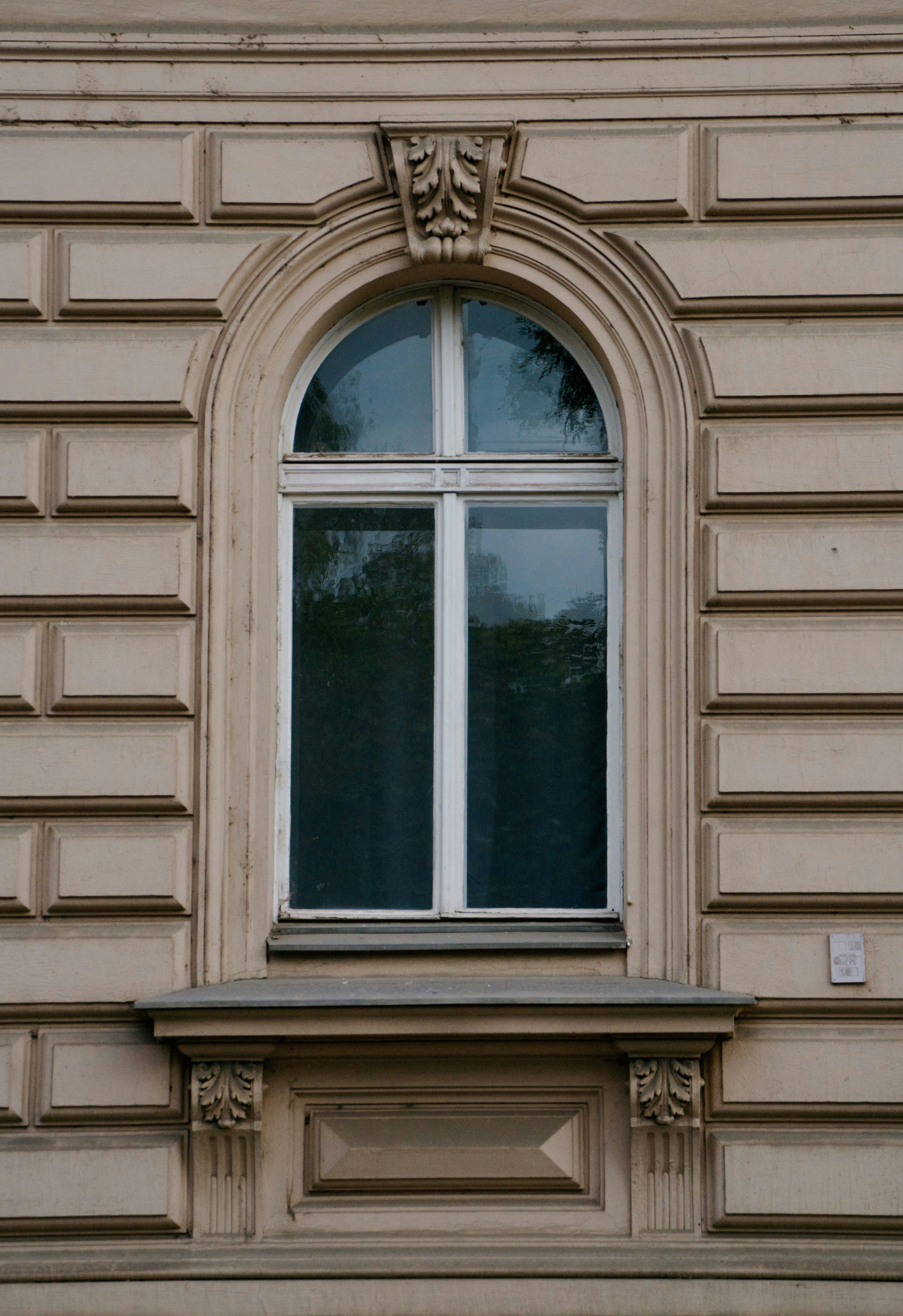 A window in Prague, depicting ancient and modern architecture and serving as preservation of history