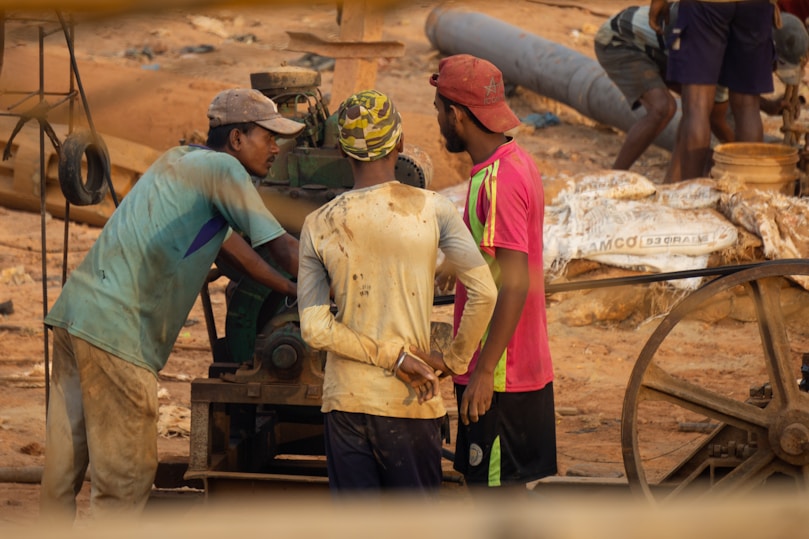 A group of men standing around a wooden cart
