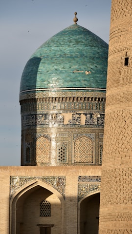 A tall building with a green dome on top of it