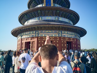 A man standing in front of a tall tower