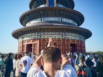 A man standing in front of a tall tower