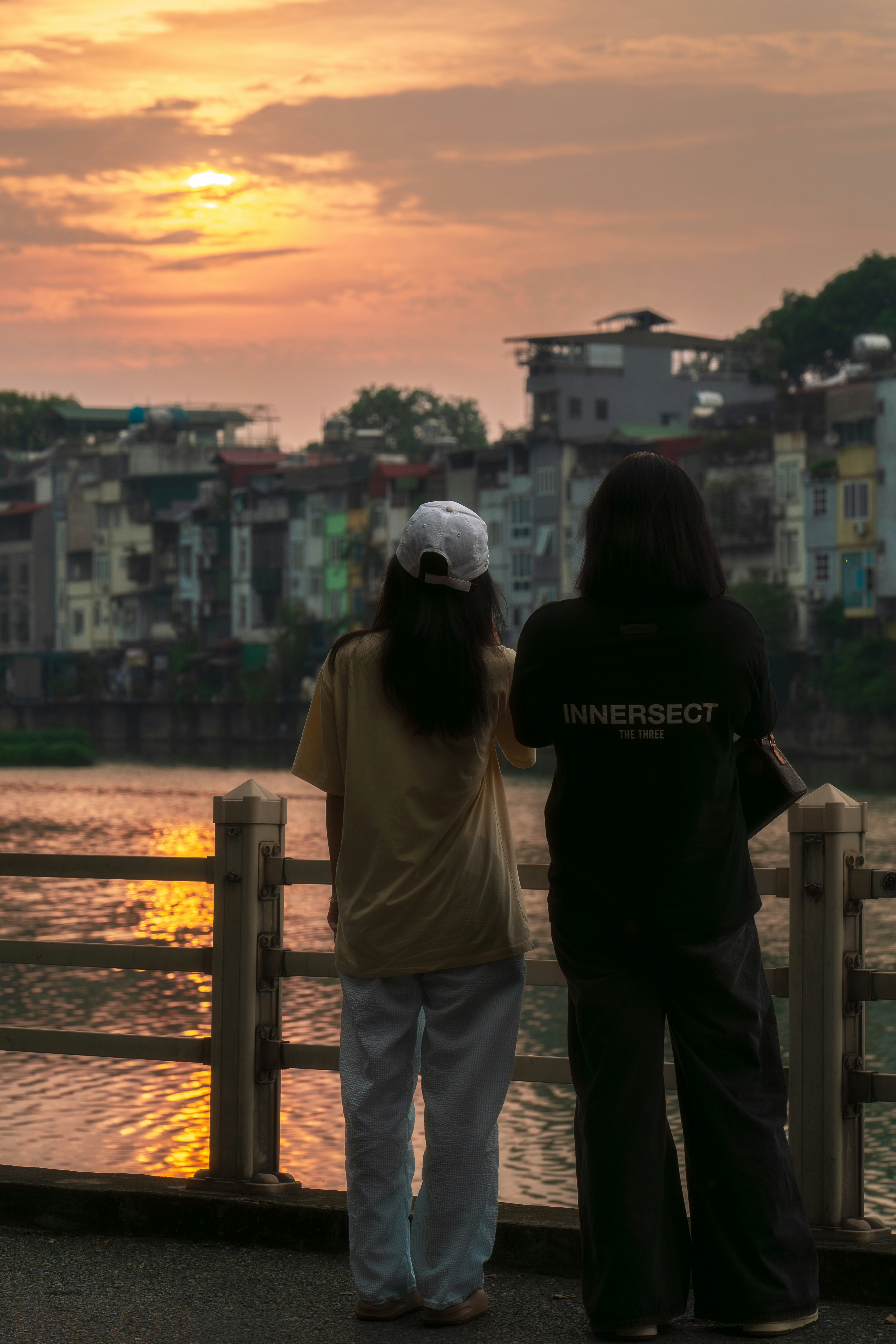 A couple of people that are standing on a bridge