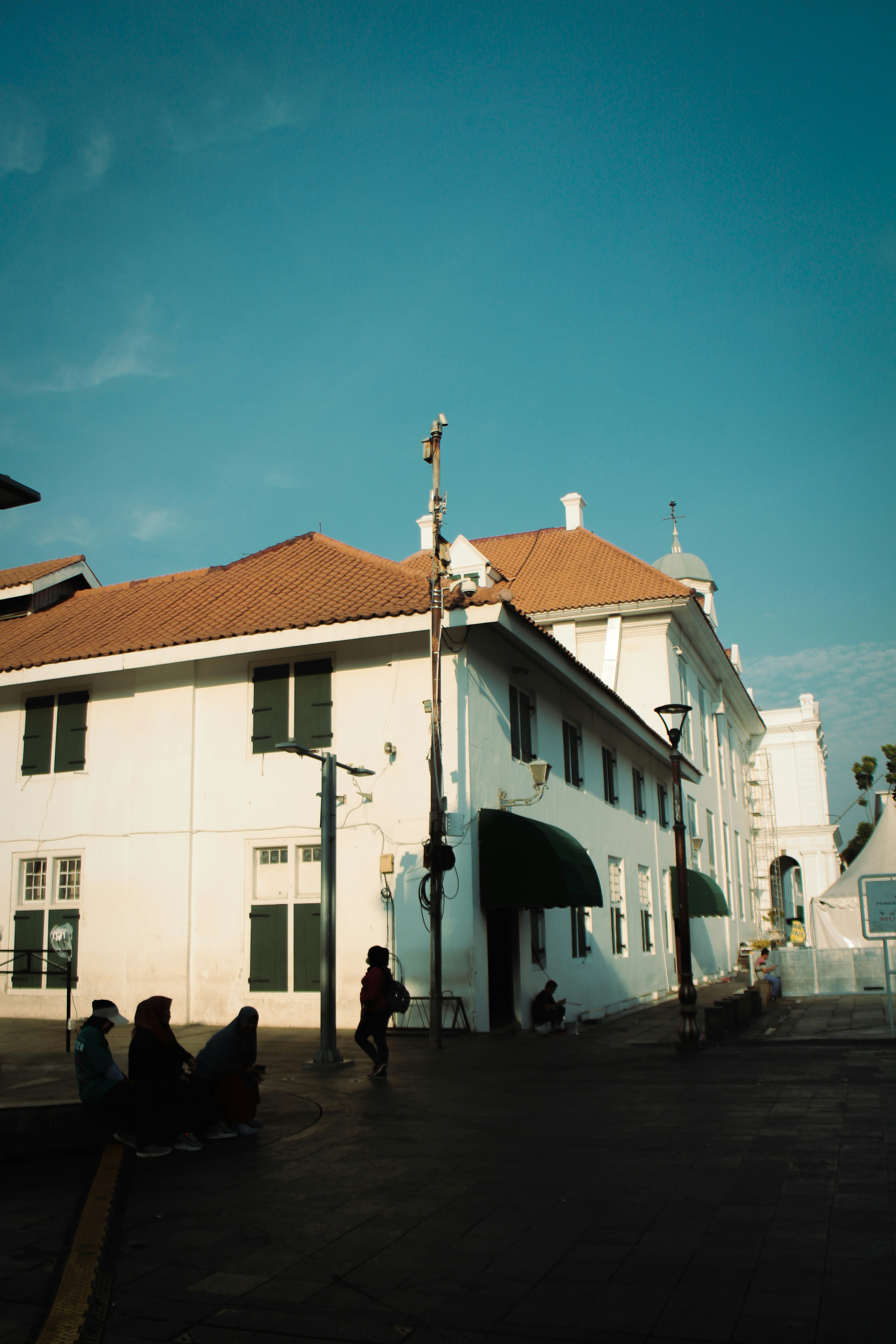 A large white building with a red roof