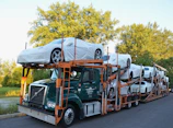 A truck with a car on the back of it