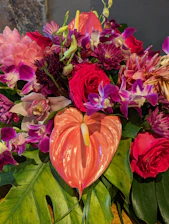 A vase filled with lots of flowers on top of a table