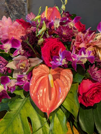 A vase filled with lots of flowers on top of a table