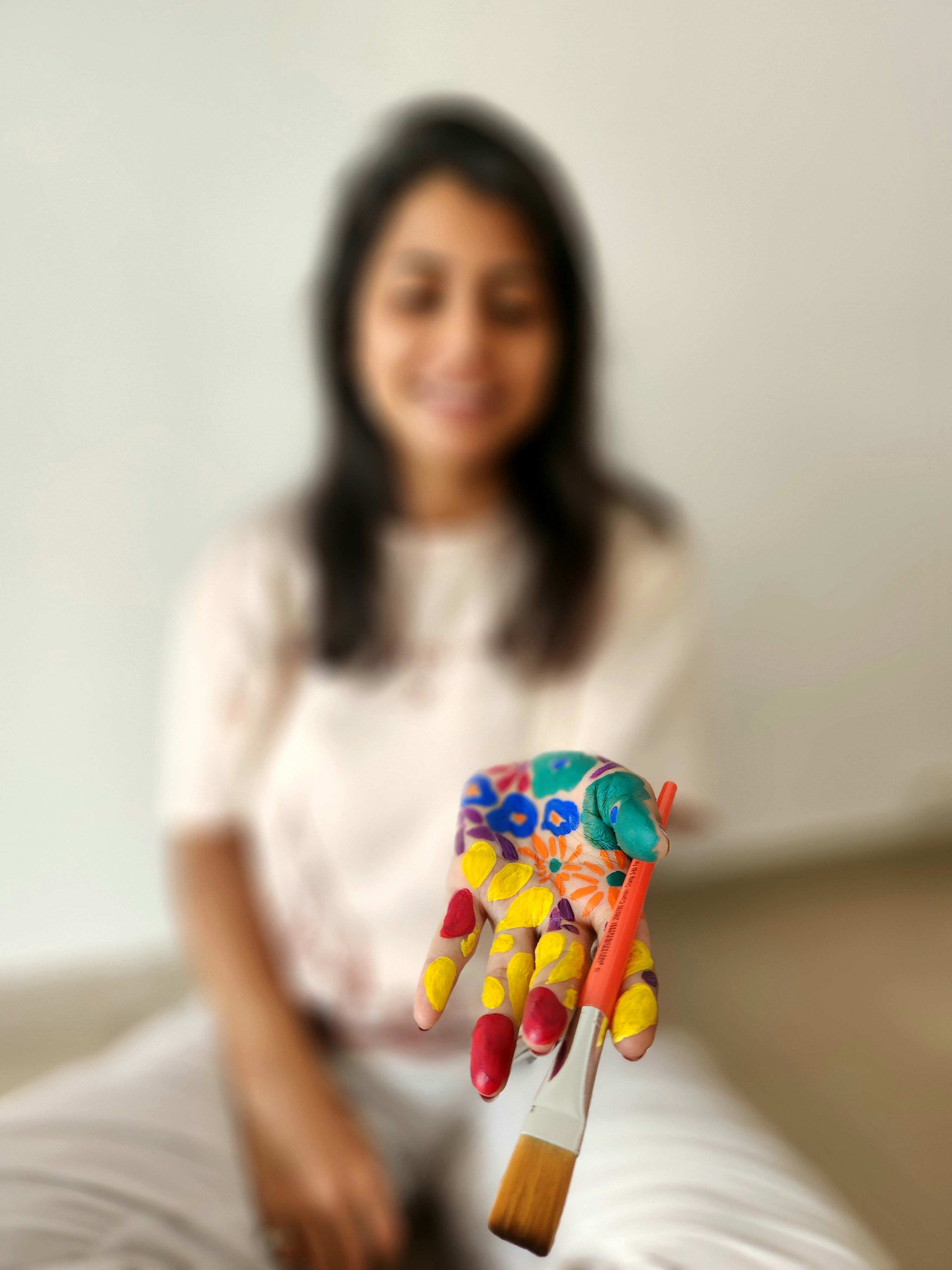 A woman sitting on a bed holding a toy