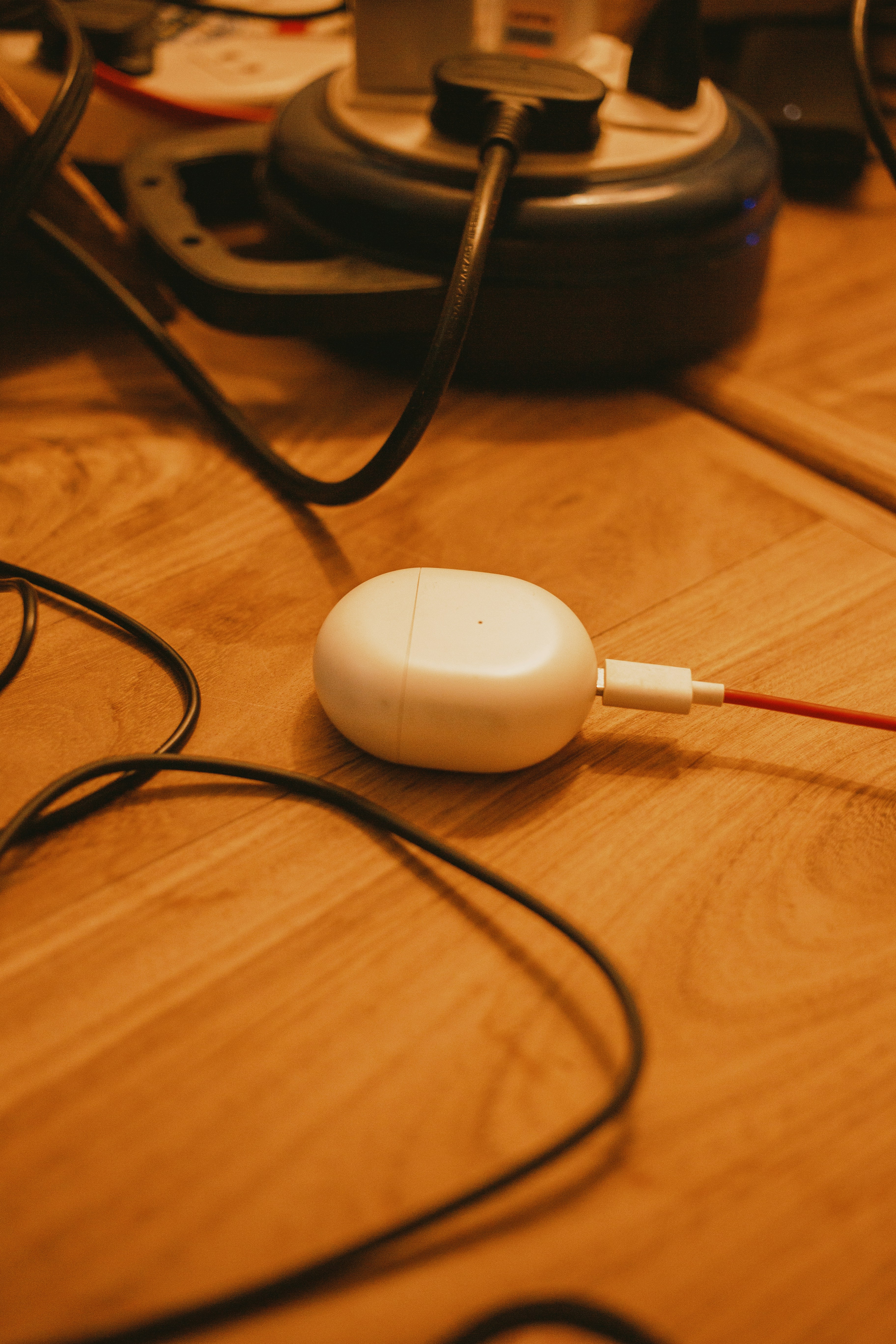A pair of white headphones sitting on top of a wooden table