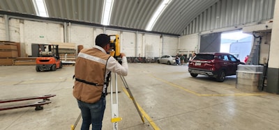 A man standing in a warehouse holding onto a rail