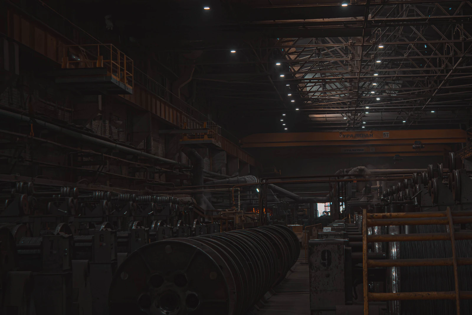 Steel pipes and hollow sections stacked in an industrial warehouse