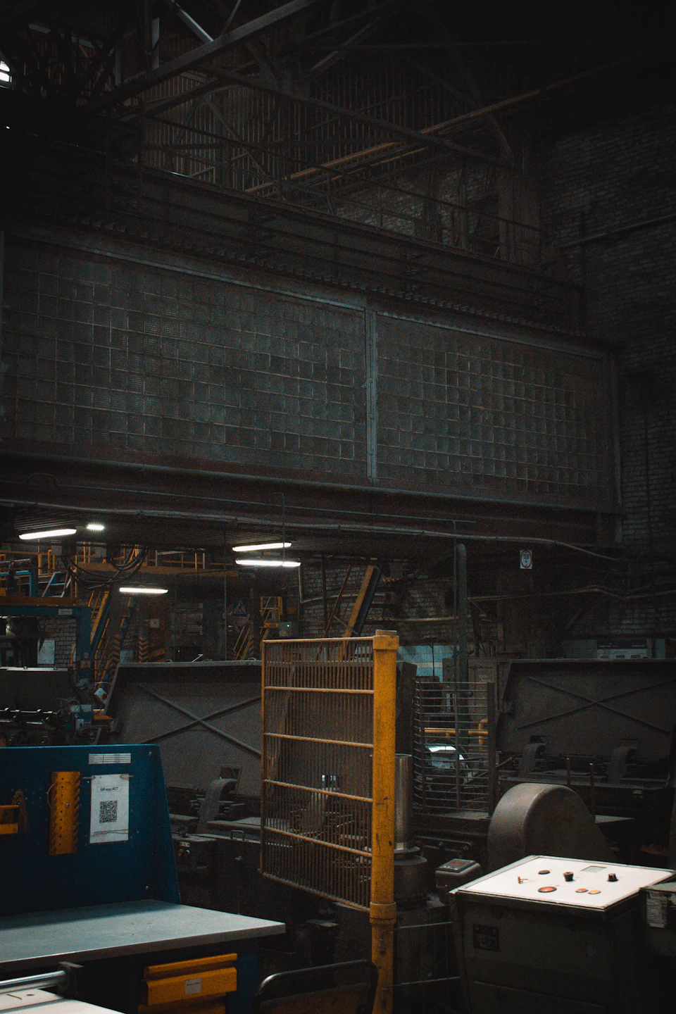 Large industrial warehouse with high ceiling and exposed beams in dimly lit interior