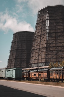 A couple of train cars sitting next to a building