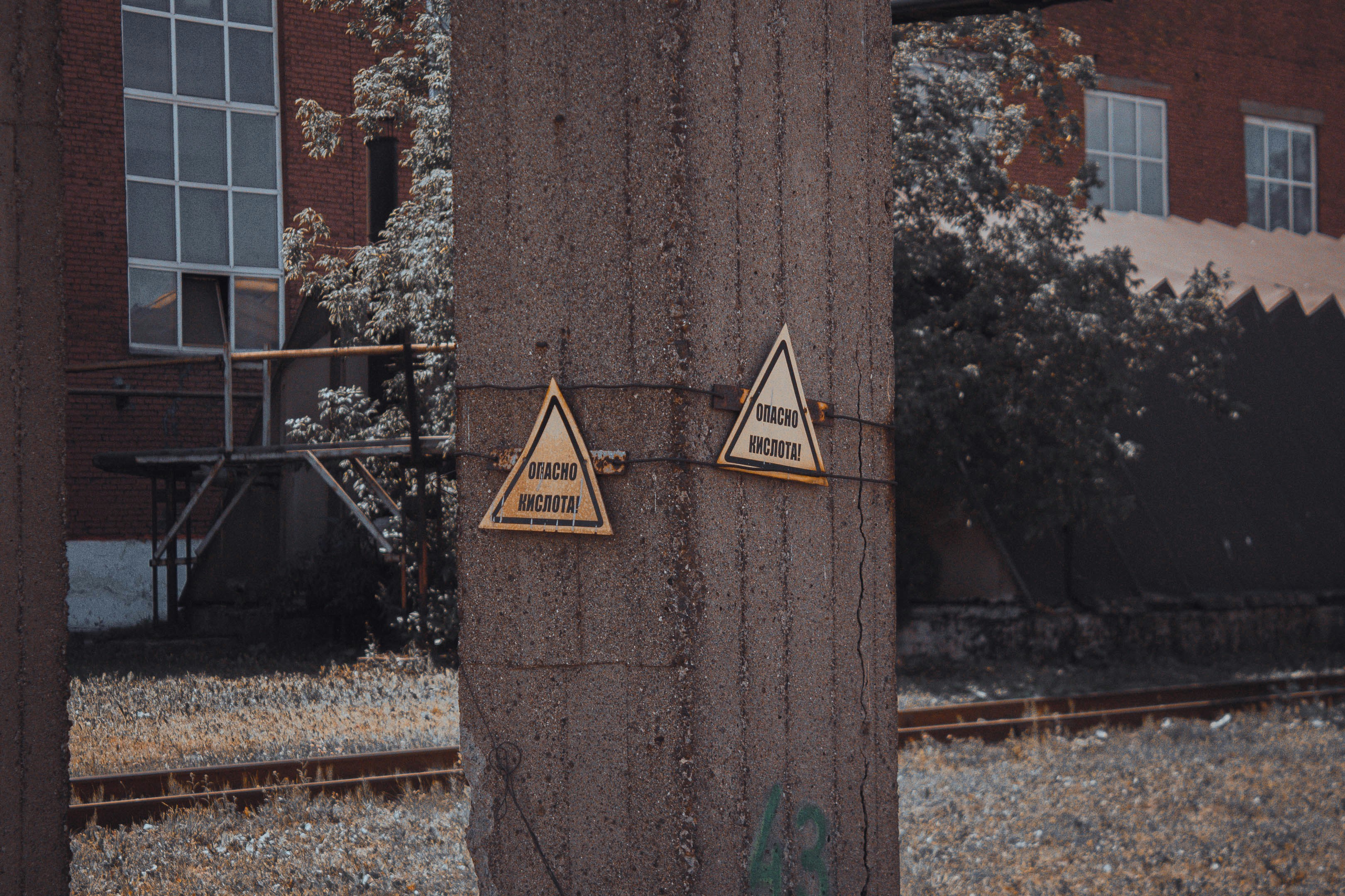 A wooden post with some signs on it