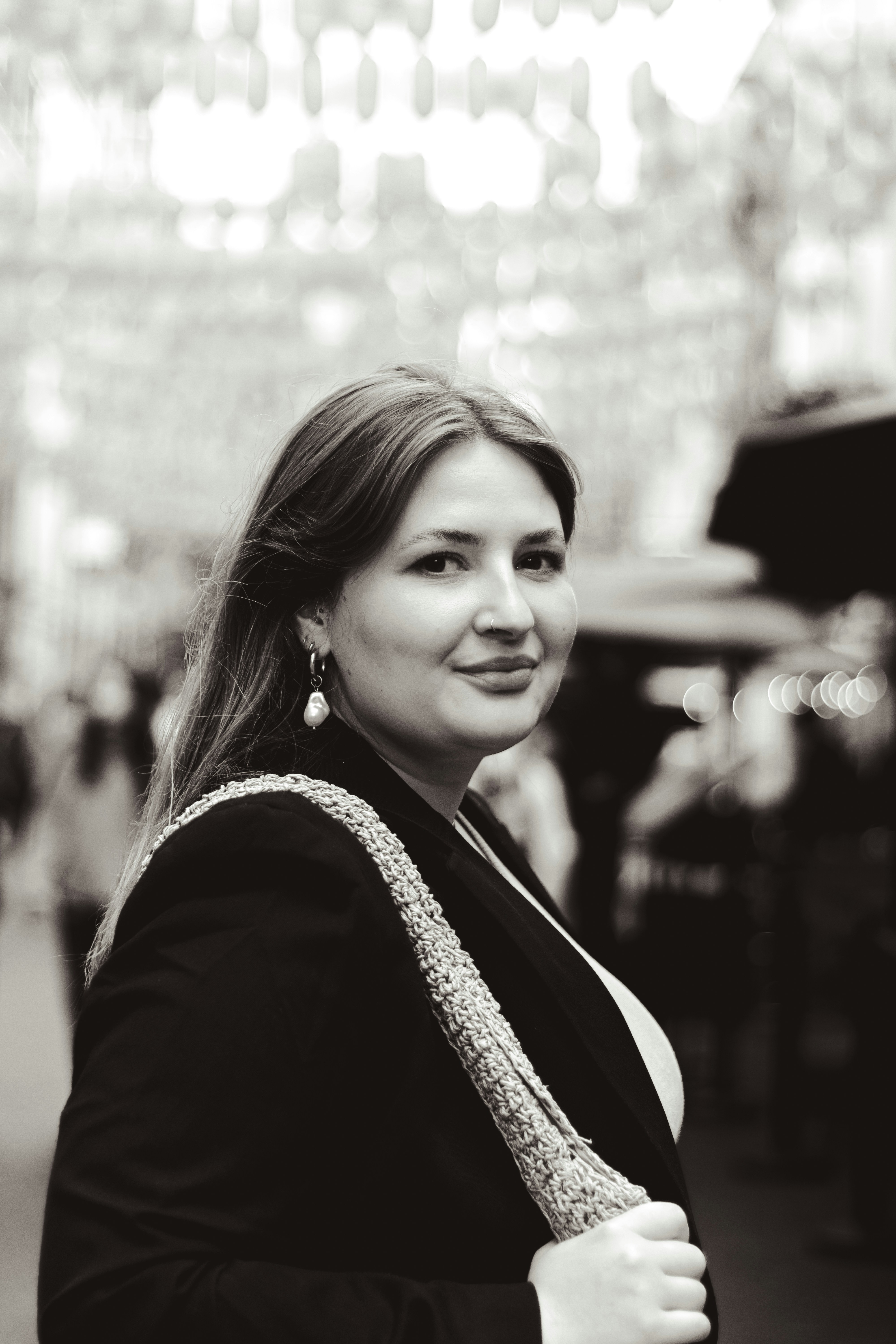 A woman in a black jacket is smiling