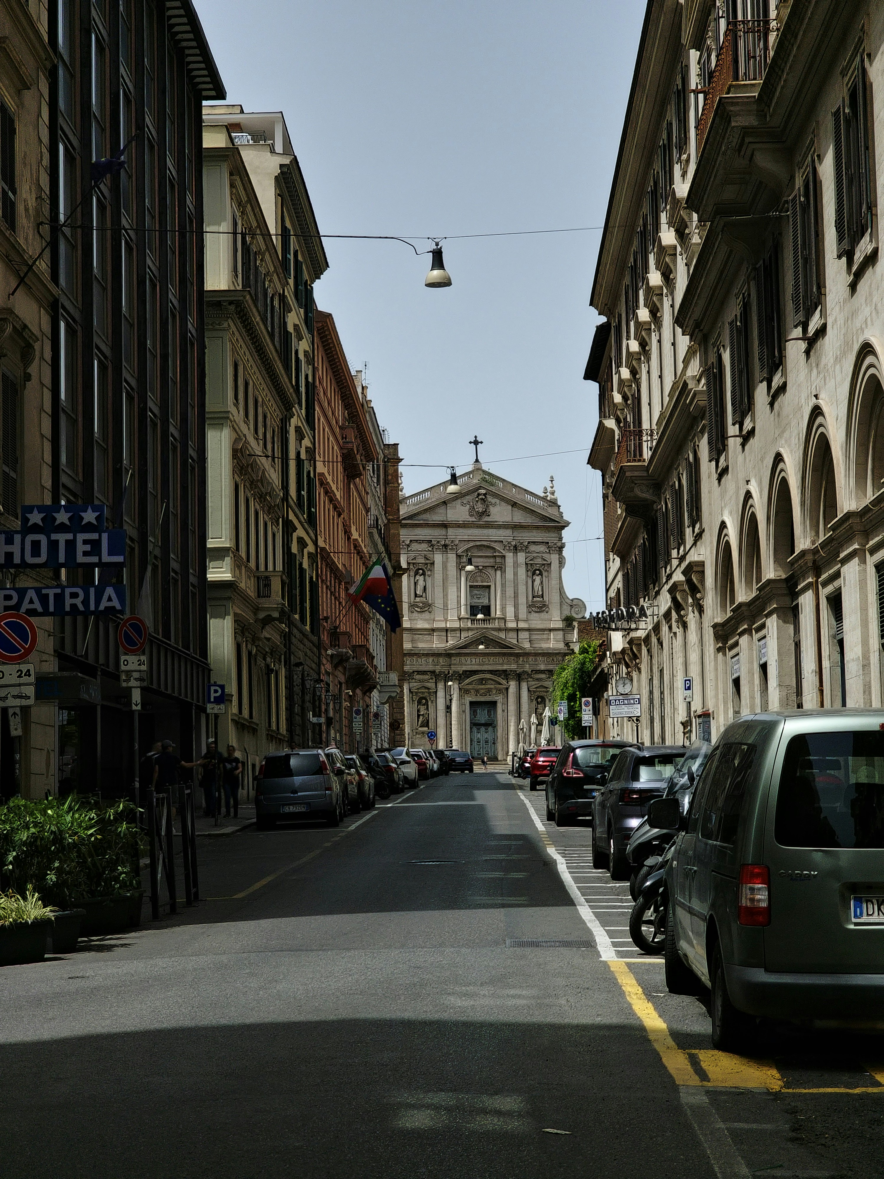 A street with cars parked on both sides of it