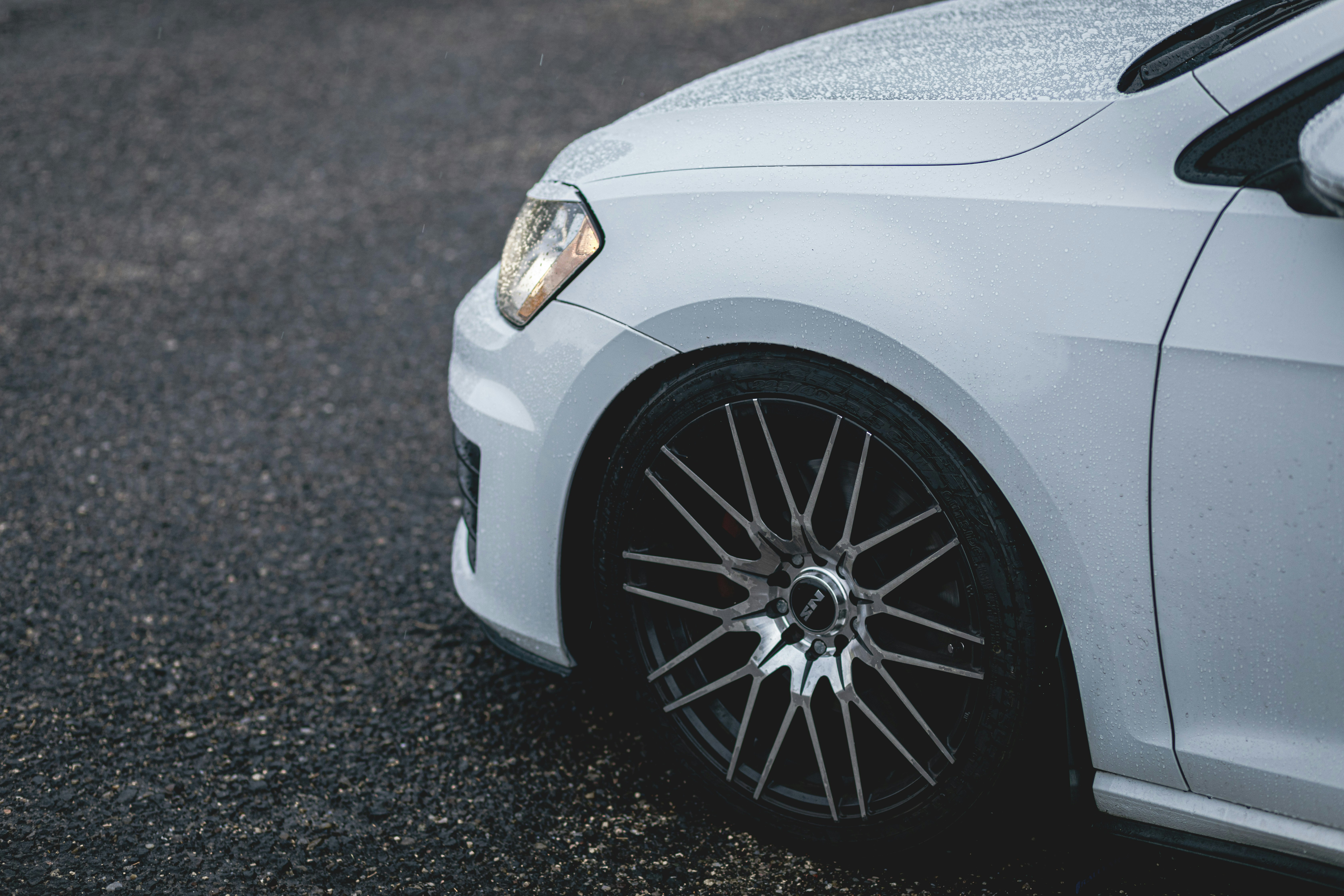 A white car parked on the side of the road